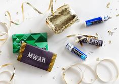 some confetti and candy are laying out on the table next to each other