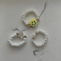 Beaded white rings. One size. Stretchy elastic. Trendy White Beaded Jewelry, White Spacer Beads Jewelry For Summer, Handmade White Rings For Summer, Adjustable Beaded Rings For Summer, Handmade Adjustable White Rings, White Rings Suitable For Summer Gifts, White Rings For Summer Gifts, Trendy White Rings For Summer, Adjustable White Ring Jewelry