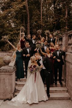 a group of people that are standing on some steps with their arms in the air