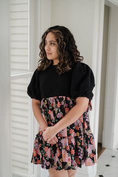 Elevate your style with our gorgeous Marta Dress! Featuring a stunning mix of black and floral fabrics, this dress boasts a boucle top and a contrasting woven skirt for a unique and eye-catching look. The empire waist and puff sleeves with tie detail add a touch of femininity and charm. Get ready to turn heads and feel confident in this must-have dress! Black Puff Sleeve Dress With Floral Print, Spring Black Dress With Balloon Sleeves, Black Balloon Sleeve Dress For Spring, Black Balloon Sleeve Dresses For Spring, Black Balloon Sleeve Dress For Fall, Black Balloon Sleeve Dresses For Fall, Floral Fabrics, Us Beaches, Floral Fabric