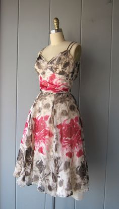 "This dress is stunning. I imagine this dress being worn in Paris while roaming through the museums and gardens. It's silk chiffon with a floral painted print in pinks and brown/taupe colors. It's flowing and light and you'll feel SO pretty in this! Fitted waist line, boning on the sides o the bust (within the slip), a gorgeous sweetheart neckline with gathering chiffon just below the bust. There are double arm straps and a hidden zipper in the back. The dress also has a triple layered skirt sli Elegant Silk Floral Dress For Garden Party, Spring Silk Floral Dress For Garden Party, Silk Floral Dress For Spring Garden Party, Chic Silk Dress For Garden Party, Feminine Silk Floral Dress For Garden Party, Spring Floral Print Silk Chiffon Dress, Silk Floral Dress For Summer Garden Party, Spring Silk Chiffon Floral Print Dress, Silk Dress For Garden Party