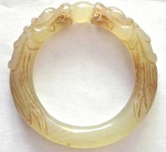 Antique-18-9th-Century-Chinese-White-Jade-Dragon-with-Ball-Small-Bangle-Bracelet Luxury Engraved Jade Jewelry, Elegant Adjustable Carved Bangle, Carved White Bracelet Jewelry, White Carved Bracelet Jewelry, White Carved Bracelet, Luxury Collectible Round Bangle, Elegant Carved Bracelet, Elegant Carved Adjustable Bracelet, Elegant Adjustable Carved Bracelet