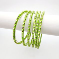 Introducing Cascade - Glass Bangles, featuring a stunning combination of lime green and soft gold. This bold and elegant accessory adds a pop of color to any outfit. Made with high-quality glass, these bangles are lightweight and comfortable to wear. Elevate your style with Cascade - Glass Bangles. *Sold as a six-piece set.*To prevent any potential damage, please put on each glass bangle individually. For a snug fit, we suggest sizing up from your usual bangle size. Glass Bangles, Elegant Accessories, Instagram Icons, Bangles Jewelry, Elevate Your Style, Green Glass, Lime Green, Snug Fit, Jewelry Sales