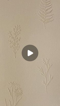 some plants are drawn on the wall with white paint