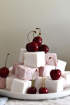 marshmallows and cherries are stacked on top of each other