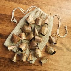 several bells are sitting on a cloth bag