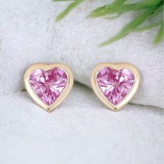 These elegant bezel-set heart-shaped Natural Pink Sapphire studs are subtle and will add color to any outfit you wear. DESCRIPTIONS FOR A PAIR OF STUDS: *Metal: 14K Yellow Gold *Metal Finish: High Shine Polish *Setting: Bezel-set *Gem Stones: Natural Sapphires *Color: Pink  *Shape: Heart-shaped *Stone Count: 2 PCS *Weight: 0.40cts T.W  *Backing Type: PushBack *Measurements: Approx. 4.8mm *Sold as a single stud or a pair. ------------------------------------- Beautiful Earring Box included Valentine's Day Fine Jewelry Heart Earrings, Fine Jewelry Double Heart Earrings For Valentine's Day, Valentine's Day Fine Jewelry Double Heart Earrings, Rose Gold Heart Cut Earrings, Pink Round Heart Earrings, Pink Round Earrings For Valentine's Day, Elegant Pink Heart Cut Earrings, Pink Round Heart Earrings For Valentine's Day, Pink Fine Jewelry Heart Earrings As Gift