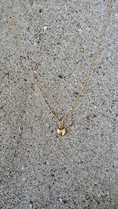 "Beautiful. Delicate Tiny gold 6mm (0.23 inches) puffed heart hangs delicately from a gold fill chain. The heart is puffed on both sides and hollow in the center. Made from high quality tarnish resistant gold fill. Shown here in 16\" length. *If you are unsure of the length you need, or would like to wear this item at different lengths, we now offer an adjustable length option! You can add an adjustable end to your necklace using this link: https://www.etsy.com/listing/791277751/necklace-extensi 14k Gold-filled Heart Necklace With Heart Charm, Gold Double Heart Charm Necklace, Tiny Dainty Heart Necklace, Gold Heart Charm Necklaces With Heart Cut, Gold Heart Charm Necklaces, Gold Heart Cut Charm Necklace, Gold Minimalist Heart Beads Necklace, Dainty Tiny Heart Necklace, Everyday Delicate Gold Heart Necklace