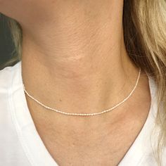 "A tiny natural Pearl beads choker necklace. Perfect as a gift for someone you love or even for yourself for birthday gift or any other special occasions like Christmas gift, Mother's day gift, Valentines day gift, a wedding, or the celebration of an anniversary. ► Please check our Add-on section to add name disc and turn your jewelry to a personal gift - https://www.etsy.com/listing/557860024/add-on-gold-filled-disc-sterling-silver?ref=shop_home_active_3&frs=1 ------------------------------ Beads Choker Necklace, Pearls Choker, Beads Choker, Gift Valentines Day, Pearl Choker Necklace, Necklace Minimalist, Beaded Choker Necklace, Natural Pearl, Layering Necklace