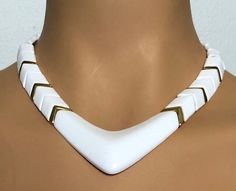 "Clean, vintage 80's lines in this white and gold chevron collar necklace by NAPIER. Foldover clasp is signed Napier and this necklace can be seen in The Napier Book by Melinda Lewis. Very good condition, measures approx. 16\" total, about 1 1/4\" at the center of the chevron." White And Gold Resin, Armor Jewelry, Vintage Fox, Book Pieces, Gold Chevron, Mardi Gras Mask, Rhinestone Bow, Cat Brooch, Green Enamel