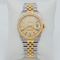 Men's Rolex 36mm DateJust 18K Gold / Stainless Steel Two-Tone Watch with Champaign Dial and Fluted Bezel. UNWORN SN# U98**** Year: 1998. Brand: Rolex. Crystal: Plastic. Gender: Men's. Case Back: Solid. Condition: Unworn. Model: DateJust 16233. Dial Color: Champaign. Case Dimensions: 36mm. Bezel Color: 18K Yellow Gold. Movement: Self-Winding (Automatic). Metal Type: 18K Gold / Stainless Steel. Bracelet / Strap: 18K Yellow Gold / Stainless Steel. Box / Certificate: Rolex Box / Certificate of Authe Timeless Gold Watch Band With Date Indicator, Timeless Yellow Gold Watches With Date Display, Gold Watch Bands With Date Display For Formal Occasions, Classic Gold Watch With Date Display, Classic Gold Diamond Watch With Date Display, Timeless Yellow Watch With Chronometer, Classic Yellow Gold Watch Accessories With Date Display, Classic Gold Watch Bands With Date Indicator, Timeless Gold Diamond Watch With Date Indicator