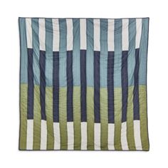 a blue and green striped quilt on a white background