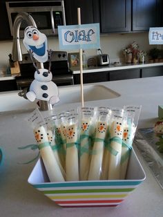 there are some toothbrushes in a bowl on the counter top with a sign