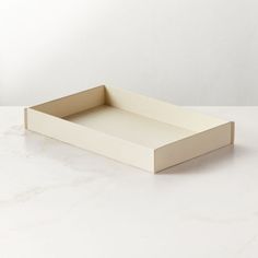 an empty white tray on a marble surface