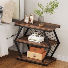 a book shelf sitting on top of a bed next to a nightstand with two books