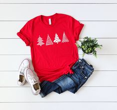 Christmas Tees - Merry Christmas Shirt - Christmas Tree Shirt - Christmas Party Shirts - Women's Christmas Tees - Holiday Tees - Winter Tees Welcome to our Etsy store. Please choose the shirt color carefully since they vary each other. V-neck section or Racerback tanks have different color options. If you pick Women's V-neck shirt , please pick a color from its color chart , which is in the listing pictures. ( Please don't pick a color from other sections) Thank you for stopping by. We are happy Snowflake Shirt, Handmade Comb, Winter Tees, Work Holiday Party, Christmas Party Shirt, Christmas Party Shirts, Womens Christmas Shirts, Womens Christmas, Christmas Tree Shirt