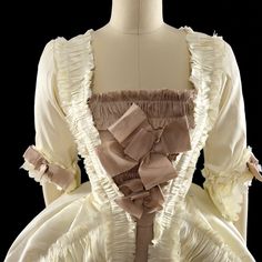 A Rococo Style gown made from polyester dupioni. The gown features an abundance of ruffles, made from the same fabric as the gown and strategically placed to add volume and movement to the dress. The separate underskirt is also decorated with ruffles and will provide additional volume and texture to the overall look of the gown. The sack back drapes elegantly over the back and hips and creates a soft, flowing silhouette.This dress can be made in many different color combinations. The front of th Couture Evening Gown With Ruffles, Couture Gown With Ruffles And Fitted Bodice, Couture Gown With Fitted Bodice And Ruffles, Formal Taffeta Gown With Ruffles, Taffeta Gown With Ruffles For Formal Occasions, Silk Ball Gown With Boned Bodice, Satin Victorian Dress With Ruffles In Ball Gown Shape, Satin Victorian Ball Gown With Ruffles, Elegant Taffeta Dress With Ruffles