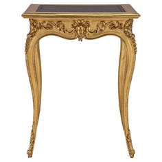 an ornate gold table with black marble top