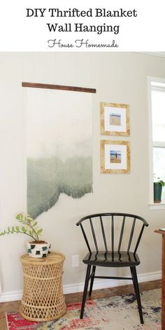 a chair sitting in front of a painting on the wall with text overlay that reads diy thrifted blanket wall hanging