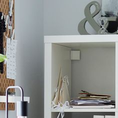 a white shelf filled with lots of papers