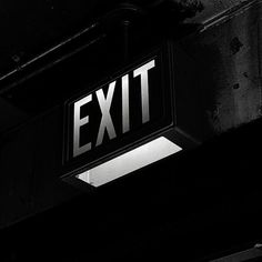 a black and white photo of an exit sign