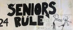 a sign that says seniors'rules on the side of a building with cartoon figures