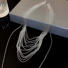 ✦ Transform your wardrobe with this Multistrand Silver Tassel Chain Necklace. Accessorize with this elegant yet simple piece for a bold and daring look. Perfect for a night out, this necklace will take your outfit to the next level. Despite the absence of diamonds, this eye-catching piece will make you shine at any party! ----------- DETAILS ----------- - Color: Silver - Materials: Brass - Necklace Length: 42.3cm - SKU: HN2699 Trendy Lariat Choker Necklace For Party, Choker Chain Jewelry For Night Out, Elegant Silver Chain Necklace For Fashion, Elegant Double Chain Necklace For Party, Metal Choker Drop Necklace For Party, Metal Drop Choker Necklace For Party, Metal Drop Necklace For Party, Trendy Silver Chain Lariat Necklace, Trendy Silver Lariat Necklace For Party