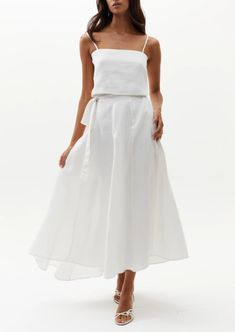 Our beloved Lola Wrap Skirt is perfectly flattering and elegant. This chic 100% linen skirt rests on the hip and flows down for a femenine silhouette. It features a tied closure with elastic waistband on the back for a perfectly adjustable fit, and on the back it has a central belt loop so that the tie stays in place. It is slightly longer on the back for a more dramatic and flirty effect. Size & Fit: Model is wearing size S/M Model’s measurements: Height: 5’ 10’’ / 179 cm Bust: 32.7’’ / 83 cm W Summer Flared Skirt With Tie Waist, Elegant Summer Gathered Wrap Skirt, Elegant Summer Skirt With Tie Waist, Chic Tie Waist Flared Skirt, Chic Relaxed Fit Maxi Skirt With Tie Waist, Chic Flared Skirt With Tie Waist, Linen Flowy Skirt For Vacation, Elegant Linen Bottoms With Lined Skirt, Flowy Linen Skirt For Vacation