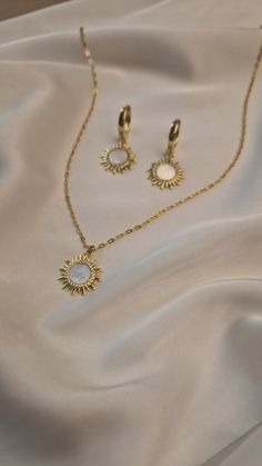 Elevate your wedding day style with our exquisite boho jewelry set. Featuring a stunning celestial pendant chain necklace and elegant gold plated sun earrings, this collection is designed for the modern bride who loves bohemian charm. Each piece is crafted with meticulous attention to detail, blending celestial motifs with timeless elegance to create jewelry that is both unique and breathtaking. MATERIAL - 18 K gold plated brass, natural mother of pearl SIZE - standard size of the necklace - 45 White Delicate Jewelry Gift, White Ethereal Jewelry For Gifts, White Dainty Jewelry With Moon Charm, White Celestial Clavicle Chain Jewelry, Elegant Moon Charm Jewelry Gift For Her, Celestial Style White Clavicle Chain Jewelry, Celestial White Clavicle Chain Jewelry, White Celestial Choker Jewelry, Bohemian Rose Gold Jewelry For Wedding