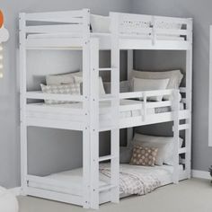 a white bunk bed sitting in a bedroom next to a wall with lights on it