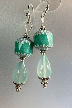 The gorgeous faceted chalcedony teardrops are the inspiration for these earrings. I paired them with equally stunning Czech Glass Cathedral beads. To set them off I added tiny seed beads and bead caps. Lightweight, elegant and eye catching! Czech Glass Beads are known for their durability and high quality. Chalcedony is a stone of balance and can bring your body, mind and spirit into harmony.  WEAR IN GOOD HEALTH! Turquoise Teardrop Czech Glass Earrings, Jade Beaded Earrings For Jewelry Making, Green Teardrop Czech Glass Jewelry, Green Czech Glass Teardrop Jewelry, Green Teardrop Drop Earrings For Jewelry Making, Turquoise Teardrop Faceted Beads Jewelry, Turquoise Teardrop Earrings With Faceted Beads, Handmade Czech Glass Teardrop Earrings, Green Beaded Dangle Teardrop Earrings