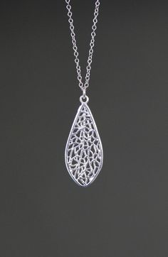 "An elegant silver filigree teardrop charm simply dangles from an open link silver chain.   The chain measures 16\" with an extension to 18\" and is finished with a silver lobster clasp. Please send a message if a different length chain is desired. A lovely necklace to give as a gift or keep for yourself. Simple and lightweight! Silver filigree charm: 15x37mm (including ring at the top) Total length of charm: 1 1/2\" Silver chain: 1.5mm Matching earrings are available... www.etsy.com/listing/138 Silver Drop Necklace With Delicate Chain, Elegant Teardrop Drop Necklace Nickel Free, Silver Teardrop Necklace With Delicate Chain, Silver Drop Necklace With Teardrop Pendant, Elegant Teardrop Nickel Free Drop Necklace, Delicate Silver Teardrop Necklace, Silver Drop Necklace With Delicate Chain And Teardrop Pendant, Delicate Silver Teardrop Pendant Necklace, Sterling Silver Teardrop Drop Necklace With Delicate Chain