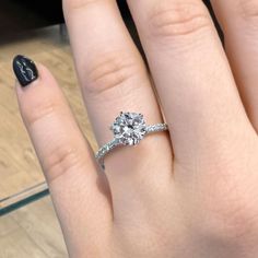 a woman's hand with a diamond ring on it