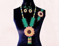 "Beautiful floral necklace. This necklace is an excellent accessory to use in a Mexican themed party and is also perfect to use with a modern outfit.  It is an ideal gift for your loved ones on birthdays, anniversaries, Mother's Day, Valentine's day, and Christmas.  Handmade ❤ Set includes beautiful matching bracelet and earrings.  Please take into account that due to the handmade nature the necklace set may have some imperfections. Necklace:  Height: 15\"  Bracelet: Width: 2 1/4\" x Length: 5 1/2\" Earrings: Length: 2.5\" Note: The sizes are approximated The actual necklace set color may look different than the colors in the pictures due to monitors' differences. The necklace set is ready to ship, and it will be shipped in a cardboard box to protect it as much as possible from damages dur Handmade Multicolor Jewelry For Mother's Day, Mother's Day Green Flower Jewelry, Handmade Flower Necklaces For Party, Handmade Flower Jewelry For Parties, Party Necklaces With Handmade Flowers, Unique Handmade Flower Jewelry For Gifts, Flower-shaped Colorful Beads Jewelry For Party, Elegant Beaded Necklace With Flower Pendant As Gift, Unique Handmade Flower Jewelry As Gift