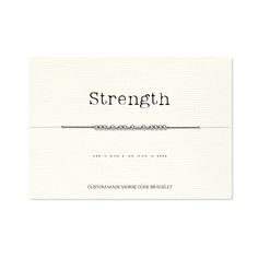 a white business card with the word strength on it and a silver chain attached to it