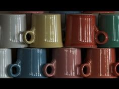 many different colored coffee mugs stacked on top of each other