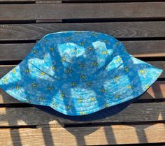 Handmade in Vancouver, B.C. One of a kind baby bucket hat.  Fits approximately 1-2 year.  reversible fabric options: dark denim or bees in light blue.  fabric is light with a sturdy brim that holds it shape so that it can be flipped up or left down. Perfect for sunny summer and fall days! Cute Blue Summer Bucket Hat, Blue Reversible Bucket Hat, Playful Adjustable Blue Bucket Hat, Fun Blue Cotton Bucket Hat, Adjustable Blue 5-panel Bucket Hat, Corduroy Bucket Hat, Denim Bucket Hat, Quality Hats, Brown Canvas