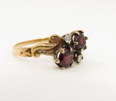 Estate 14k yellow gold garnet and diamond ring size 6. great shape. 2.5 grams. 8.6mm wide. two 4.6 natural garnets and two small diamond. Victorian Gold Three Stone Ring, Victorian Gold Three-stone Ring, Formal Gold Three Stone Rings, Vintage Yellow Gold Three Stone Rings, Heirloom Yellow Gold Three Stone Ring, Gold Three Stone Cluster Ring, Antique Three Stone Gold Jewelry, Vintage Three Stone 14k Gold Birthstone Ring, Antique Gold Three-stone Jewelry