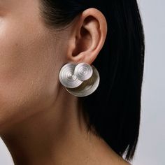 This earring is a 3 earrings in one! It is combination of Orbit double sided and Orbit geometrical earring. Back side works as a ear closure and can be worn with any other post earring. A truly one of the kind statement earring that speaks for itself. Can be worn combining front or back part, back side with any other post earring, only front side as Orbit geometrical earring. Will be handmade in limited quantity of 10 pairs. - Get as a pair or as a single statement earring. - Available in silver Modern Earrings Simple, Luxury Single Earring In Contemporary Style, Luxury Minimalist Sphere Earrings, Luxury Contemporary Jewelry With Unique Design, Elysian Theory Earrings, Modern Silver Cartilage Earrings, Modern Round Single Ear Cuff, Minimalist Silver Clip-on Jewelry, Contemporary Single Metal Earring