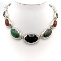 This is a stunning Taxco sterling silver necklace featuring onyx, jasper, turquoise and another unidentified polished black striped stone. This piece is in the style of Enrique Ledesma. The silver is impeccably blended with the stones. Clearly, with this level of attention to detail and skill, one may assume this piece was indeed done by a true master.  Taxco silver jewelry has a fascinating and rich history. The indigenous people of Taxco were using silver long before the arrival of the Spanish in the Americas. This indigenous society mined silver and used it to make gifts and offerings to the Aztec gods. The people of Taxco utilized their ingenuity and creativity centuries before the arrival of a man named William Spratling. However, it was indeed this man who put into motion what collec Aztec Gods, Taxco Silver Jewelry, Nature Necklace, Indigenous People, Multi Stone, Sterling Silver Necklace, This Man, Stone Necklace, Sterling Silver Necklaces