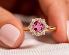 "Genuine Pink Tourmaline Halo Diamond Ring, 14k Gold Gemstone Jewelry, Wedding Engagement Promise Ring, Pink Gemstone Ring, Gift For Daughter ★ ★ ★ ★  CUSTOM/DUTY-FREE SHIPPING WORLDWIDE, BUYERS DON'T HAVE TO PAY ANY CUSTOM FEES WHILE IMPORTING ★ ★ ★ ★  Details Made to order Material: 14k/18k Gold Color Options: Yellow Gold, White Gold, Rose Gold,  ★ Center Stone:  Pink Tourmaline, Cushion Size: 6 mm Approx Weight (Ct): 0.96 ★ Accent Stones:  Diamond Round Size: 2 mm * 6 Nos, 1.5 mm * 8 Nos Appr Pink Sapphire Ring With Halo Design For Formal Occasion, Formal Pink Sapphire Ring With Halo Design, Pink Round Cluster Ring With Halo Setting, Fine Jewelry Pink Halo Ring With Accent Stones, Pink Round Cluster Ring With Prong Setting, Pink Round Halo Ring With Accent Stones, Pink Sapphire Ring With Accent Stones For Wedding, Pink Halo Ring With Accent Stones, Pink Sapphire Promise Ring With Halo Setting