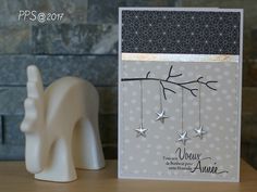 a card with stars hanging from it next to a small white elephant figurine