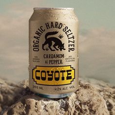 a can of cootee beer sitting on top of a rock