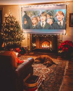 a living room filled with furniture and a christmas tree in front of a flat screen tv