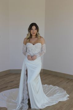 a woman in a wedding dress posing for the camera