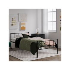 a black metal bed frame in a bedroom with white walls and wood flooring, along with a rug on the floor