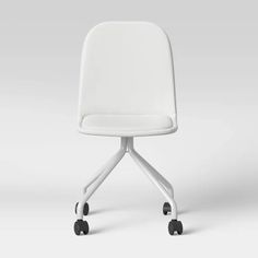 a white chair sitting on top of a white table