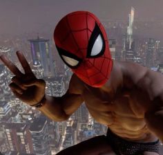 the spider - man is standing in front of a cityscape with his hands up