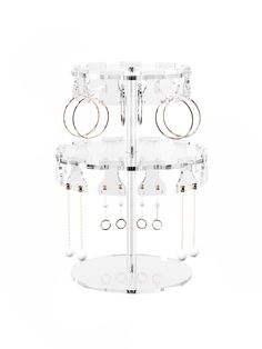 an acrylic display case with multiple rings and chains hanging from it