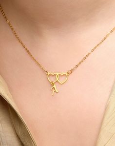 Embrace the elegance of love with our exquisite 22K Gold Plated Double Heart Initial Necklace. This stunning piece is a celebration of connection and individuality, blending the timeless allure of 22K gold plating with the personal touch of engraved initials. Key Features: 1.Material: Crafted with precision, this necklace features high-quality 22K gold plating, ensuring a radiant and enduring finish. 2.Double Heart Design: Two hearts entwined, symbolizing the beauty of shared moments and lasting Gold Plated Jewelry For Valentine's Day Anniversary, Valentine's Day Anniversary Gift Gold Plated Jewelry, Gold Plated Double Heart Necklace For Mother's Day, Gold Plated Necklace For Anniversary On Valentine's Day, Gold Plated Necklaces For Valentine's Day, Valentine's Day Gold Plated Necklace, Gold Delicate Chain Necklace For Anniversary, Gold Double Heart Necklace For Mom, Gold Double Heart Necklace Gift For Mom